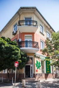 a building with a balcony on top of it at Sofia Central Guest Rooms in Sofia