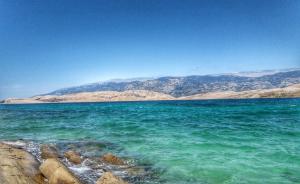 a large body of water with mountains in the background at Pearl apartments Pag in Pag