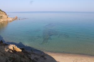 a large body of water with a sandy beach at "CASA CANSELLA" a few steps from the sea in Gonnesa