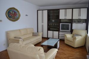 a living room with two couches and a tv at Apartments Antonio in Baška