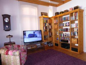 a living room with a television and book shelves at Großstrasse 18 A in Leer