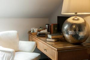 a room with a table with a lamp and a chair at Townhouse No 12 in Huddersfield