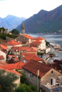 a town with red roofs and a body of water at Marina House in Perast