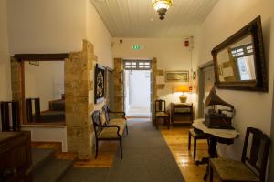 a room with a hallway with chairs and a mirror at Nostos Hotel in Chania