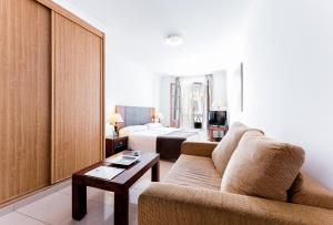 a living room with a couch and a bed at Toboso Apar - Turis in Nerja