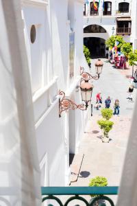 a white building with lights on the side of a street at Toboso Apar - Turis in Nerja