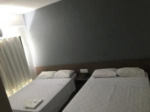 Voodi või voodid majutusasutuse Hotel Comodoro toas