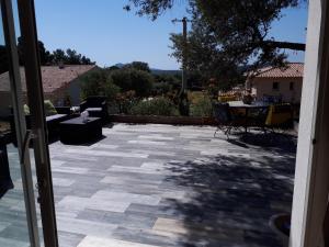 an open door to a patio with a table at gite tomasini sabrina zirilla in Monacia-dʼAullène