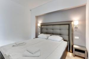 a bedroom with a large white bed with two pillows at Gdynia Comfort Apartments Władysława IV in Gdynia
