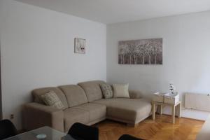 a living room with a couch and a table at Sweet Home Zadar in Zadar