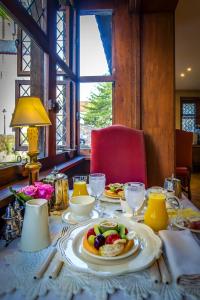 a table with plates of food on top of it at B&B Exclusive Guesthouse Bonifacius in Bruges