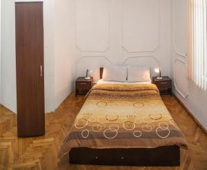 A bed or beds in a room at Central GuestHouse Five Corners