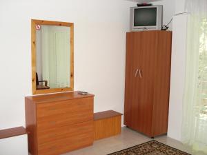 a room with a mirror and a dresser and a television at Villa Exotica in Balchik