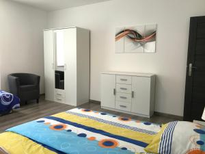 a bedroom with a bed and a desk and a chair at Royal apartment in Karlovy Vary