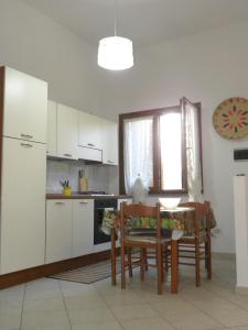 a kitchen with a table and chairs and a window at Lovely House in Nebida