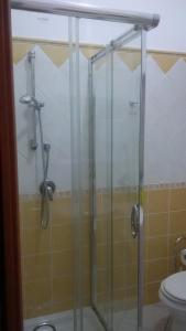 a glass shower in a bathroom with a toilet at Lovely House in Nebida