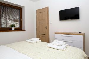 A bed or beds in a room at Apartmán Chopok Juh Nadia