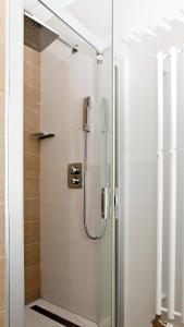 a shower with a glass door in a bathroom at Apartmán Chopok Juh Nadia in Horná Lehota