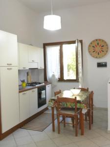 a kitchen with a small table and a table and chairs at Lovely House in Nebida