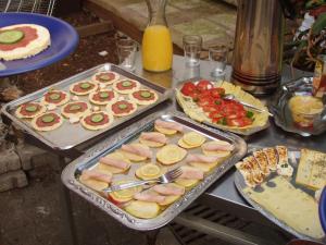 a table with several trays of food on it at Gerry `s Backpacker in Konstanz