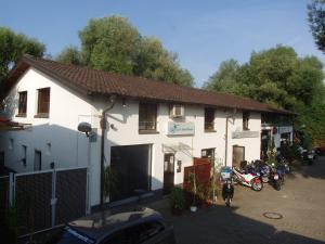 a white building with motorcycles parked in front of it at Gerry `s Backpacker in Konstanz