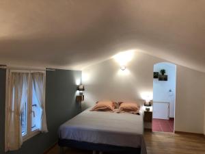 a bedroom with a bed and a window at La Rainette in Flayosc