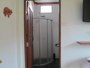 a glass door leading into a room with a window at Asiana House in Khao Lak