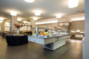 a buffet line in a restaurant with fruits and vegetables at Altafulla Mar Hotel in Altafulla