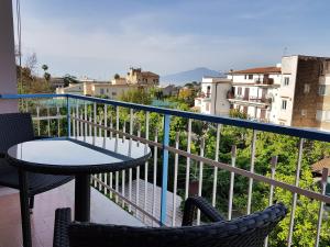 a patio with a table and chairs on a balcony at Villa Susy Relais in Sant'Agnello
