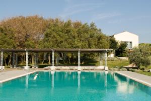 a swimming pool with a pavilion in a yard at Casale del Mare in Castiglioncello