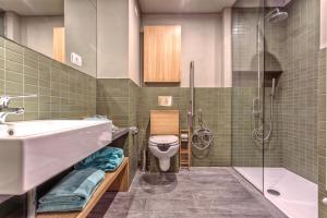 a bathroom with a sink and a toilet and a shower at Casale del Mare in Castiglioncello