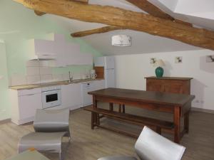 a kitchen with a table and chairs in a room at Gîtes Dans une Maison d'hôtes "Lieu Dit Cruzel" in Moissac