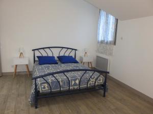 Un dormitorio con una cama con almohadas azules. en Gîtes Dans une Maison d'hôtes "Lieu Dit Cruzel" en Moissac