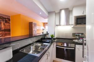 a kitchen with a sink and a microwave at Lets Holidays RENOVATED APARTMENT NEAR BEACH in Tossa de Mar +12 photos