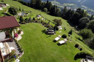 an aerial view of a house on a green field at Landgut Thalerhof in Telfes im Stubai
