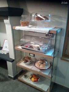 a glass shelf with some food on it at 'L Calié in Valdieri +28 photos