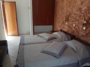 a bedroom with a bed with two pillows on it at Matina Studios in Kefalos