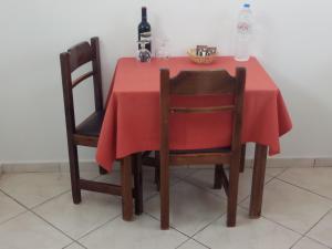 a table with two chairs and a red table cloth at Matina Studios in Kefalos