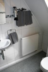 a bathroom with a sink and a toilet at Haus zum Schlosspark in Veitshöchheim +29 photos