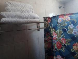 a pile of towels on a rack in a bathroom at Matina Studios in Kefalos