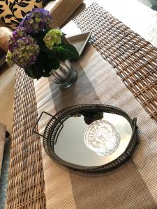 a table with a glass plate and a vase of flowers at Ferienwohnung Südel in Malente +23 photos