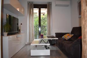 ein Wohnzimmer mit einem Sofa und einem Tisch in der Unterkunft Moderno apart centro in Madrid