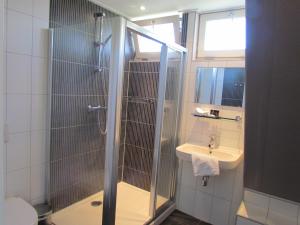 a bathroom with a shower and a sink at Wellness Suites Dellewal in West-Terschelling +5 photos