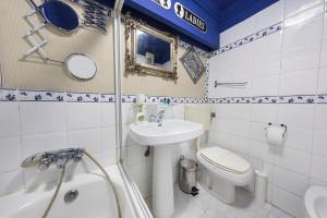 a bathroom with a sink and a toilet and a tub at Picoas Artistic Flat in Lisbon +20 photos
