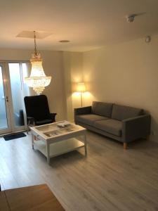 a living room with a couch and a coffee table at Engen Apartment in Bergen