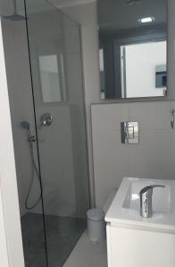 a bathroom with a shower and a sink at Modern Seaview Beach Studio Limassol in Limassol