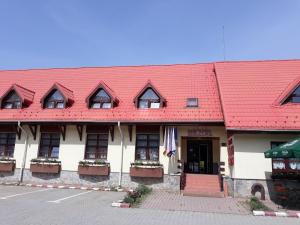 a red roofed building with a red roof at Motel din Darste in Săcele