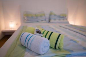 a bed with towels and a toy train on it at Apartments Braut Krk in Krk