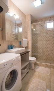a bathroom with a washing machine and a toilet at Apartments Inspiration in Budva