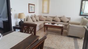 a living room with a couch and a table at Atlazia Suites in Alinda